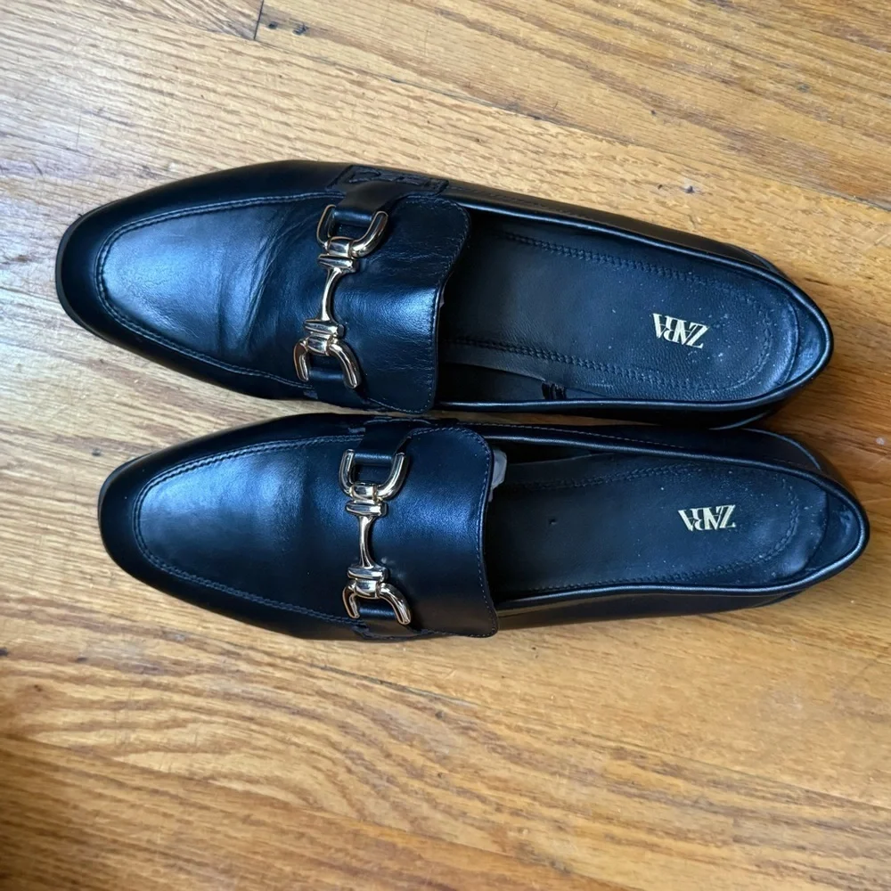 Zara Black Leather Slip on Loafers with Gold Horsebit Buckle Trim.